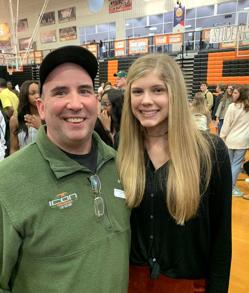 Icon coach with an athlete at a high school signing day