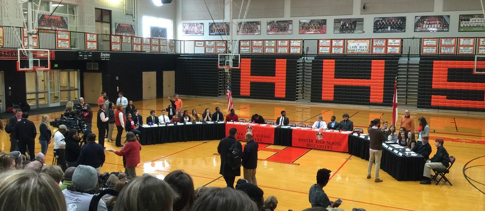 Signing day ceremony in a high school gym